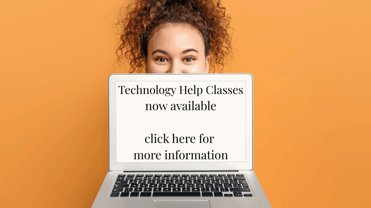 a person holds a laptop in front of their face with a screen displaying information about available technology help classes and a prompt to click for more information.